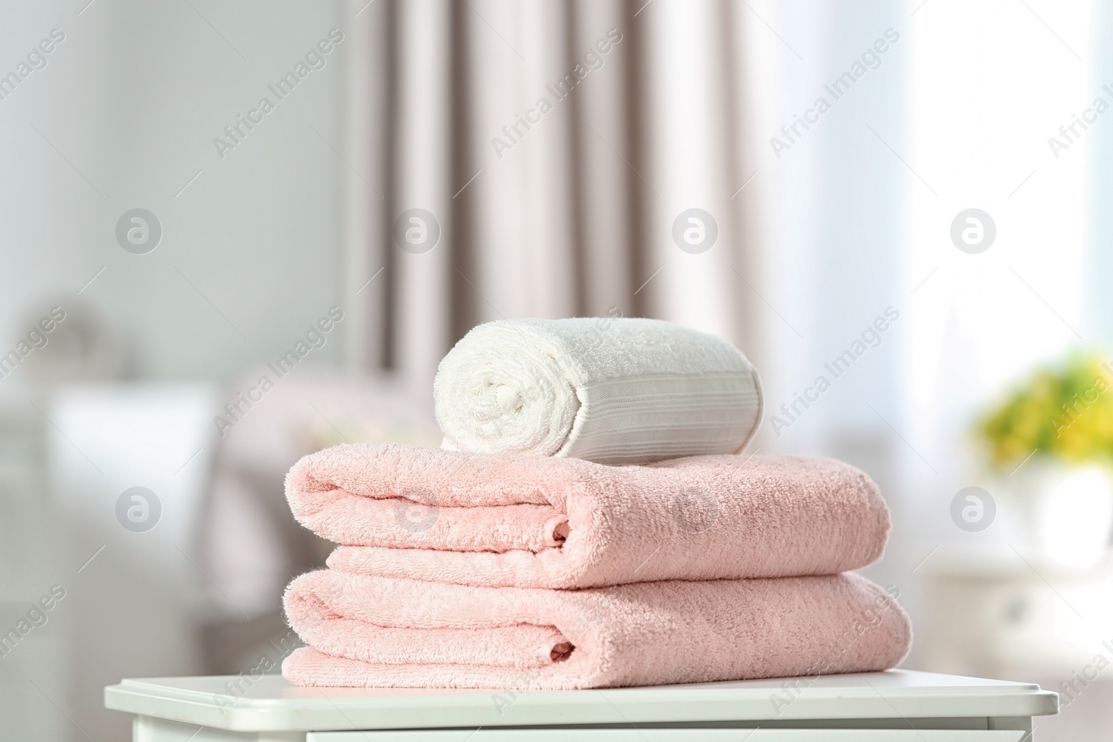 Photo of Clean soft terry towels on table indoors