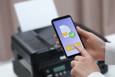 Photo of Man using printer management application on mobile phone indoors, closeup and space for text