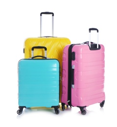 Modern suitcases for travelling on white background