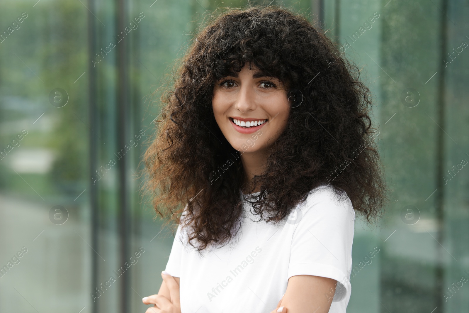 Photo of Portrait of beautiful woman posing on blurred background. Attractive lady smiling and looking into camera