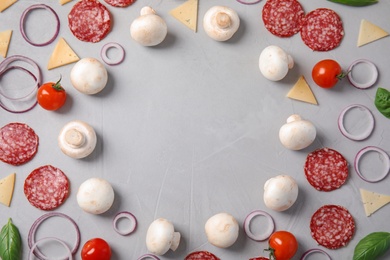 Photo of Flat lay composition with ingredients for pizza on light background, space for text