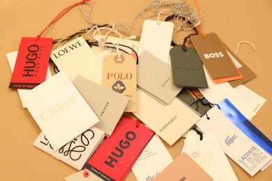 Photo of Leiden, Netherlands - December 6, 2023: Different clothing tags on kraft paper sheet
