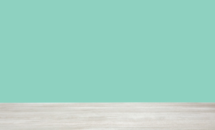 Empty wooden surface on mint background. Mockup for design