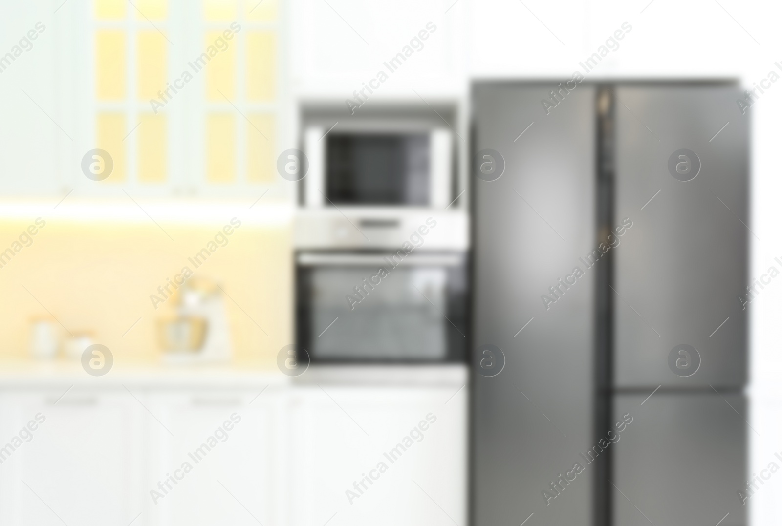 Photo of Blurred view of modern kitchen interior with stylish furniture