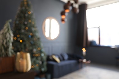 Photo of Blurred view of living room interior with Christmas tree and festive decor