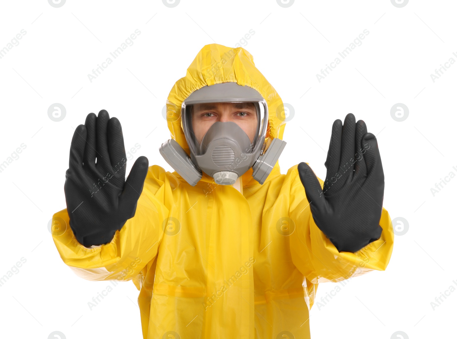 Photo of Man in chemical protective suit making stop gesture on white background. Virus research