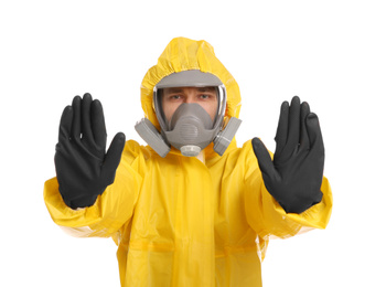 Photo of Man in chemical protective suit making stop gesture on white background. Virus research