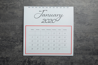 Photo of January 2020 calendar on grey stone background, top view