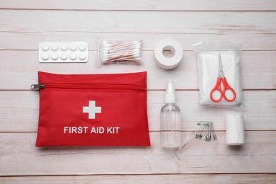 Photo of Flat lay composition with first aid kit on wooden table