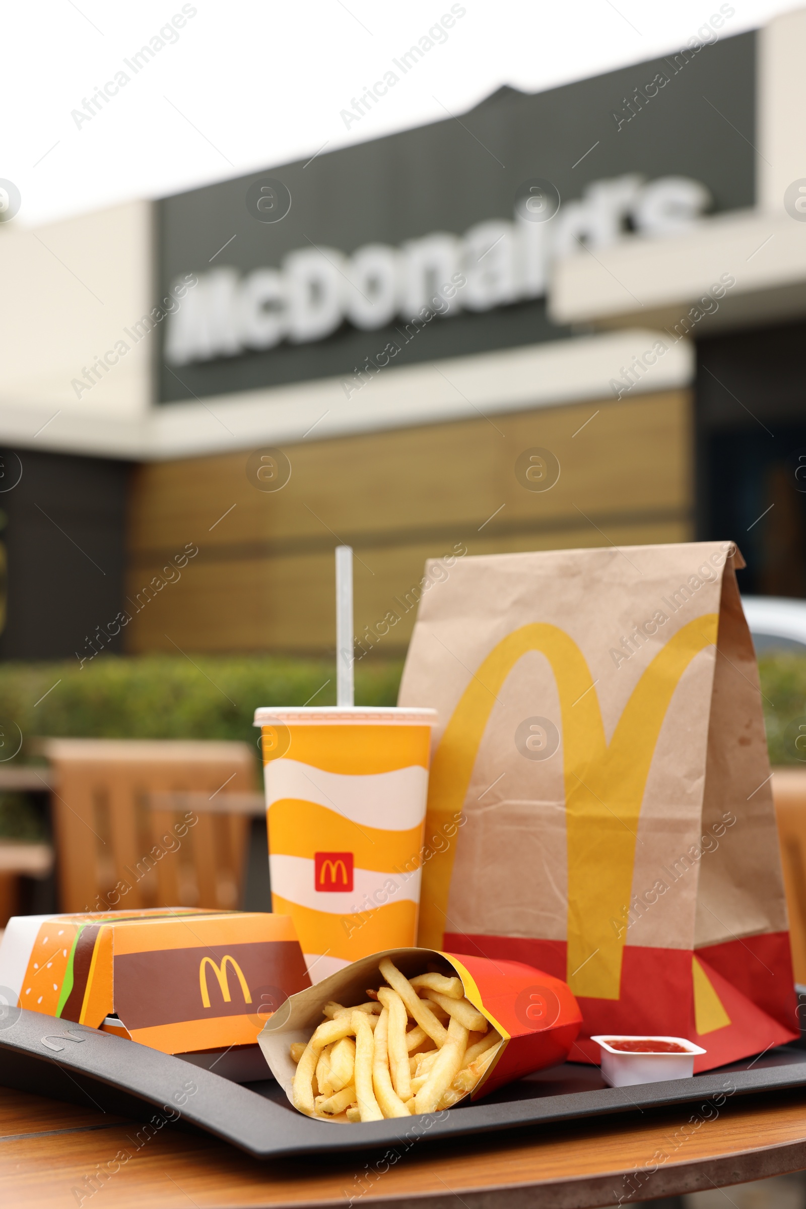 Photo of Lviv, Ukraine - October 9, 2023: McDonald's menu on wooden table outdoors