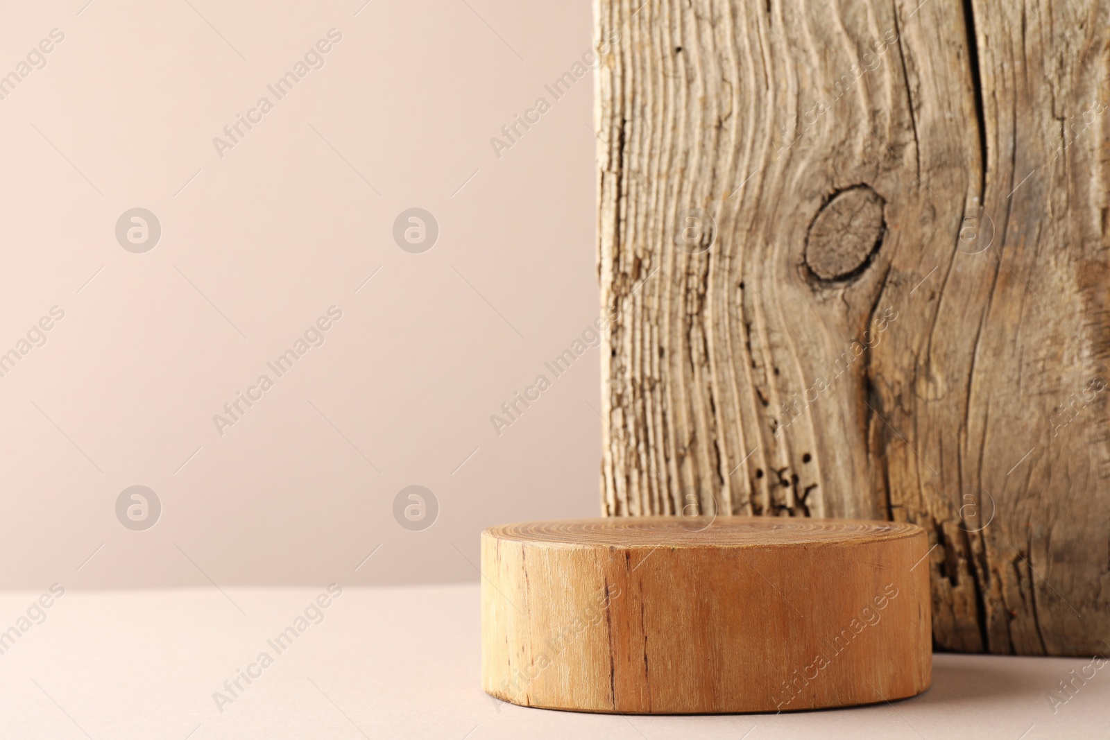 Photo of Presentation for product. Wooden podium on beige background. Space for text