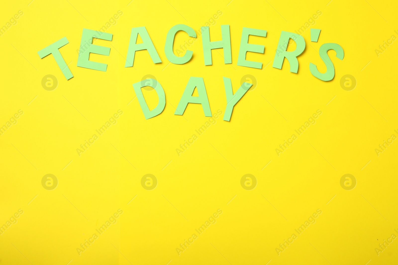 Photo of Words TEACHER'S DAY on yellow background, flat lay. Space for text
