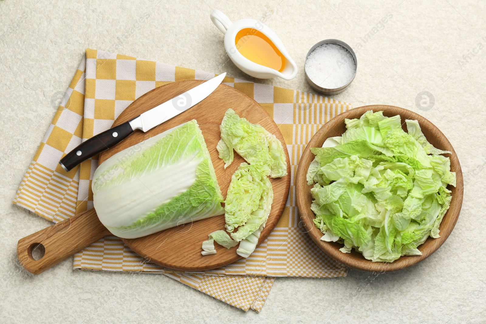 Photo of Cut fresh Chinese cabbage, oil and salt on light table, flat lay