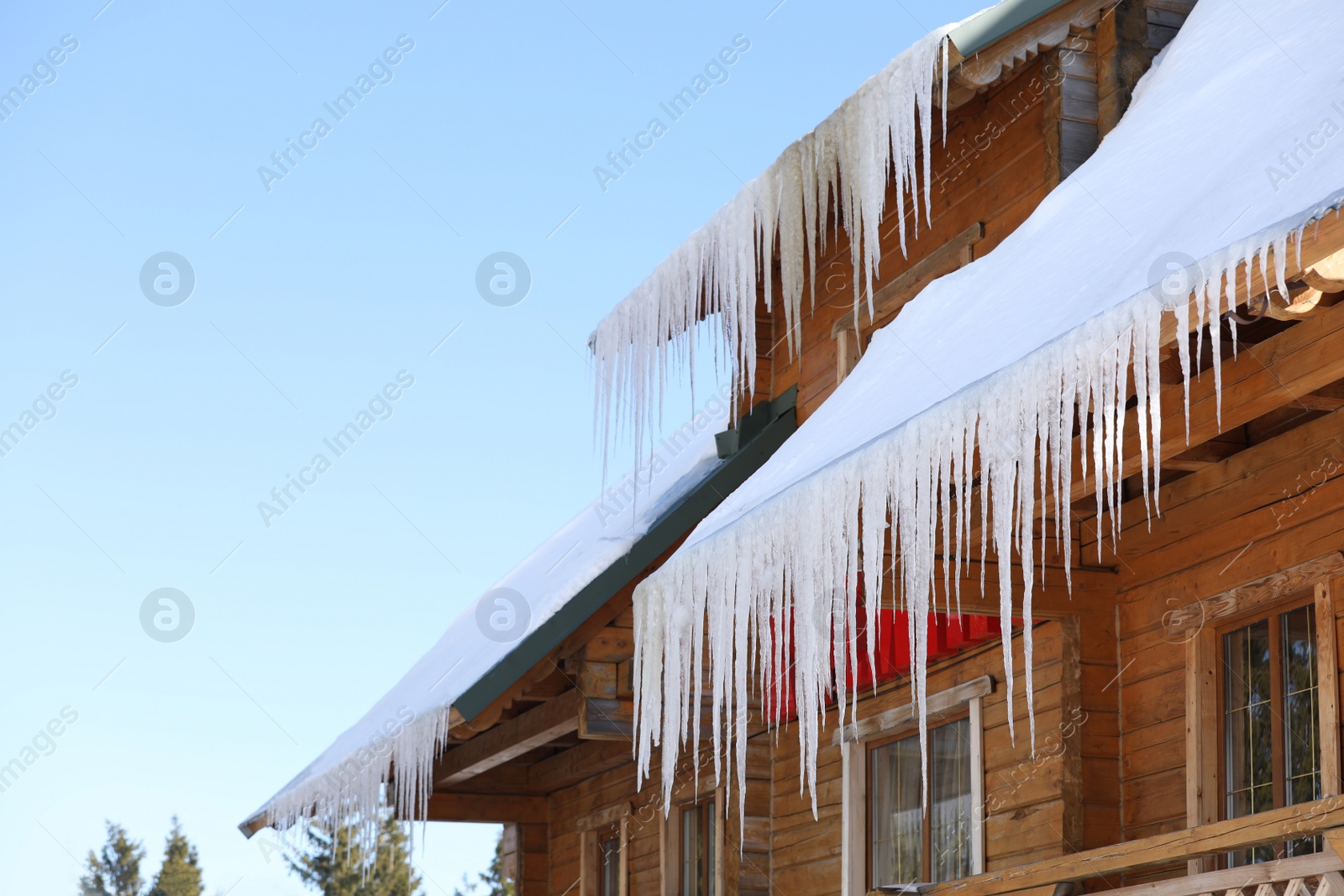 Photo of House with icicles on roof. Winter season