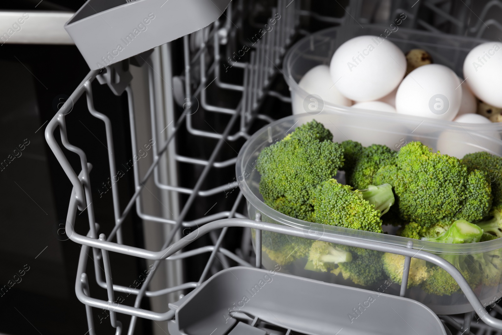 Photo of Cooking raw broccoli and eggs in modern dishwasher, closeup