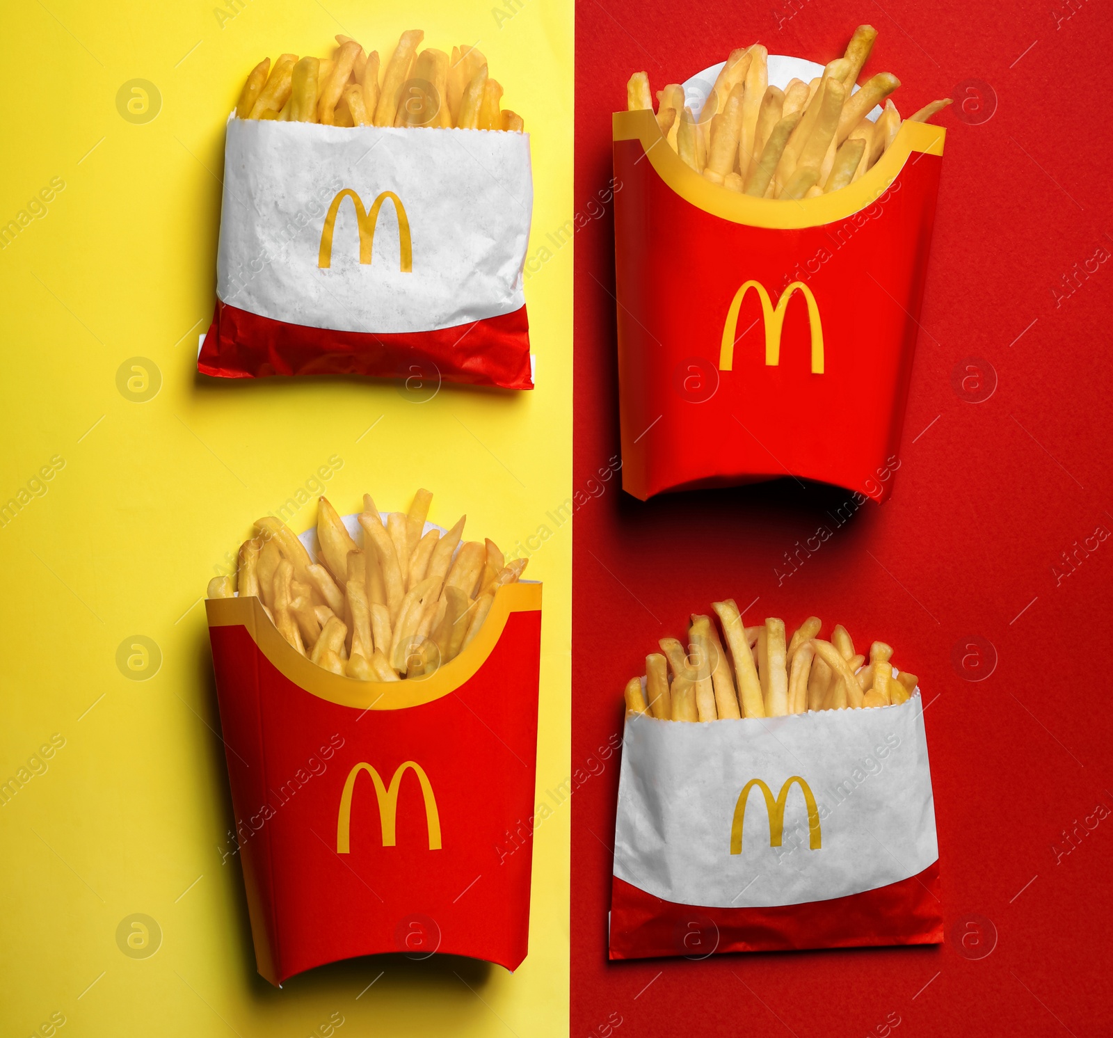 Photo of MYKOLAIV, UKRAINE - AUGUST 12, 2021: Small and big portions of McDonald's French fries on color background, flat lay