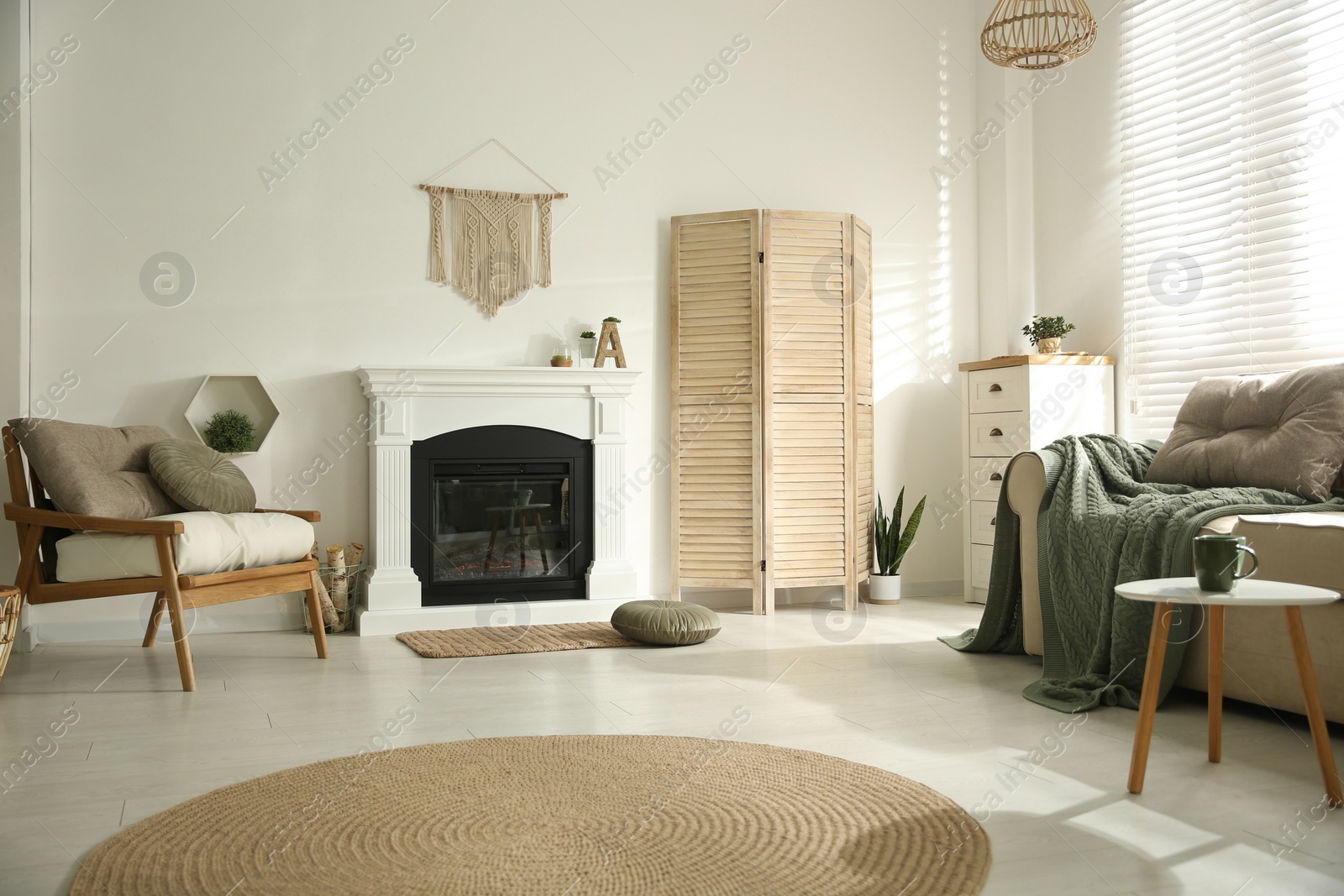 Photo of Bright living room interior with fireplace and basket of firewood