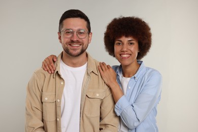 Photo of International dating. Portrait of happy couple on light grey background