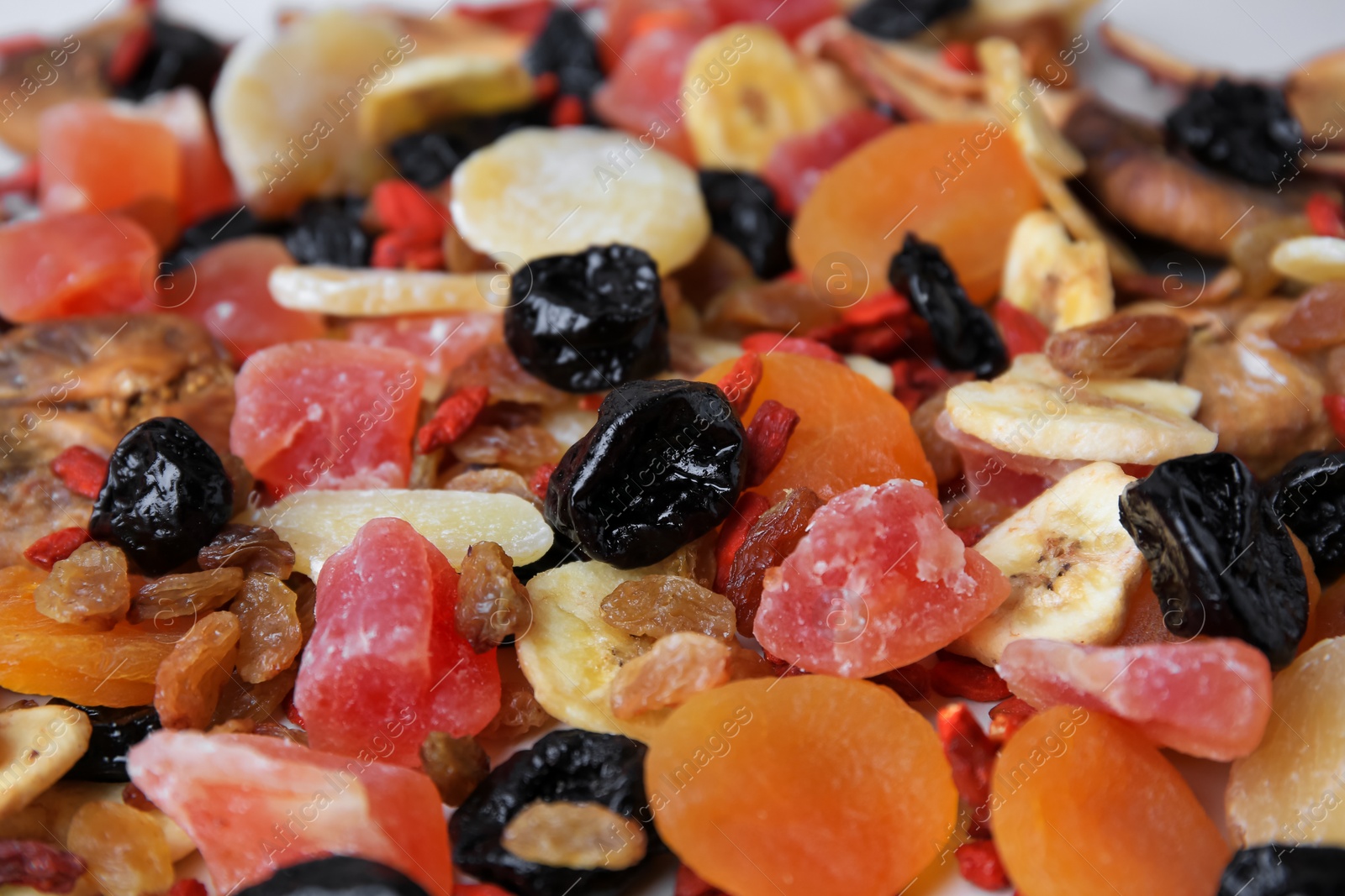 Photo of Pile of different tasty dried fruits as background, closeup