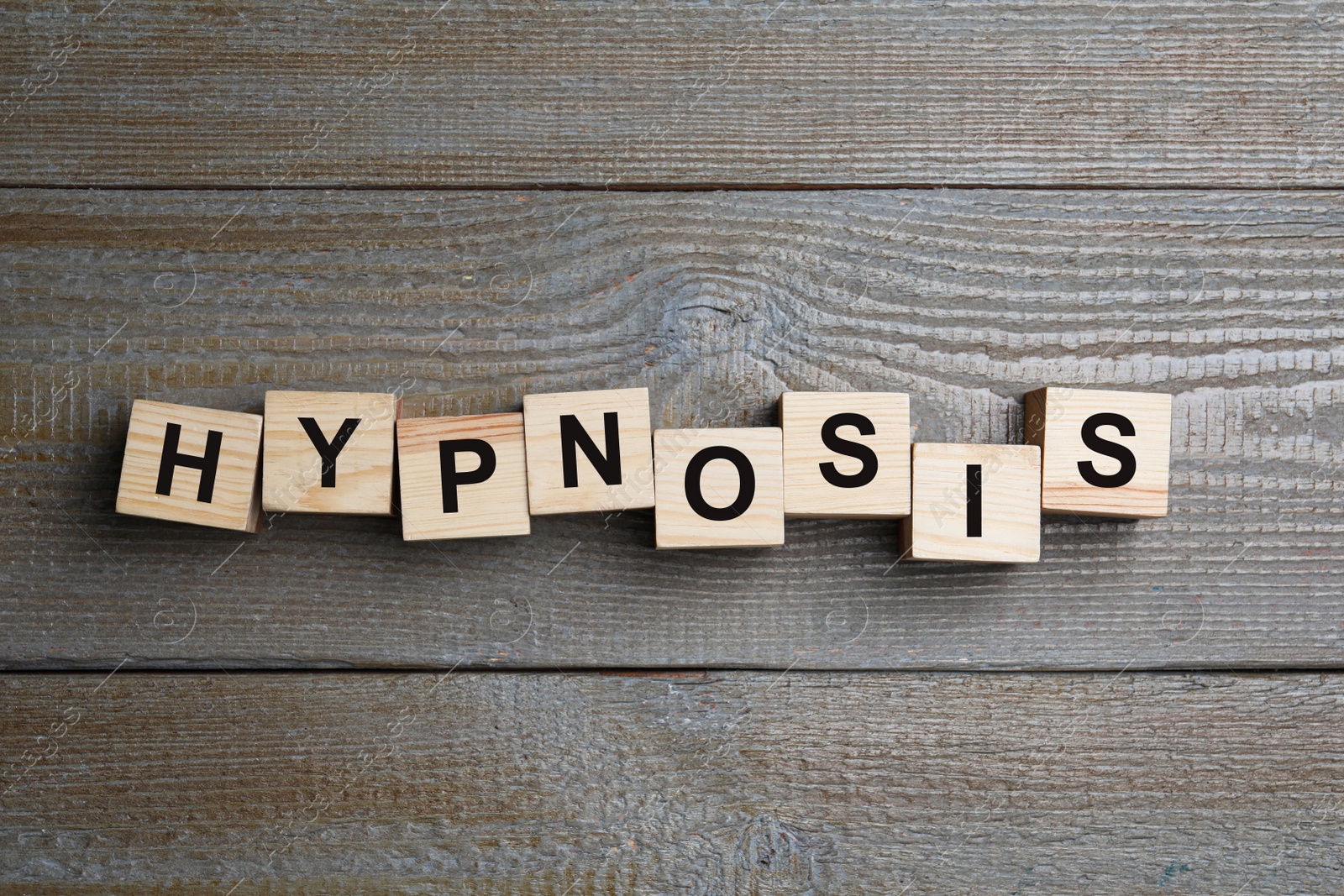 Photo of Blocks with word HYPNOSIS on wooden background, flat lay