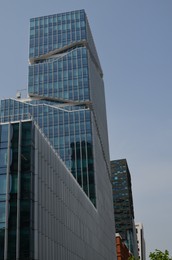 Photo of Exterior of beautiful modern skyscraper against blue sky