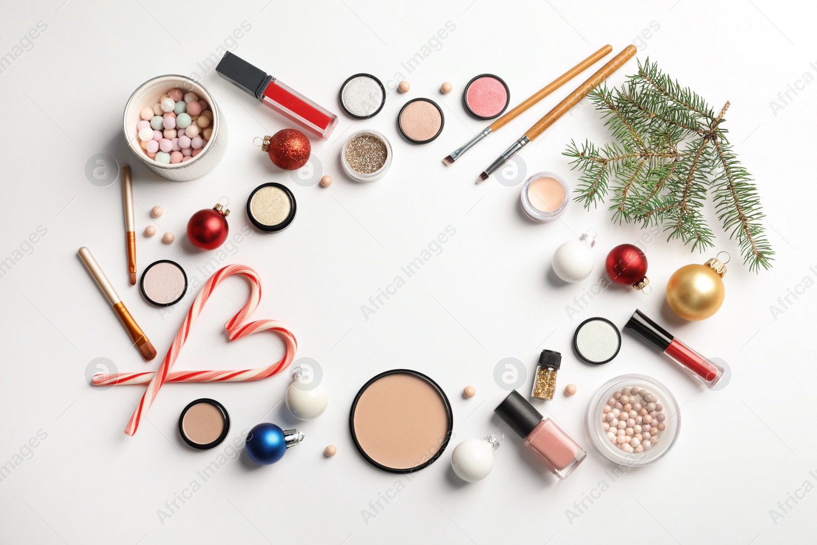 Photo of Flat lay composition with makeup products and Christmas decor on white background. Space for text