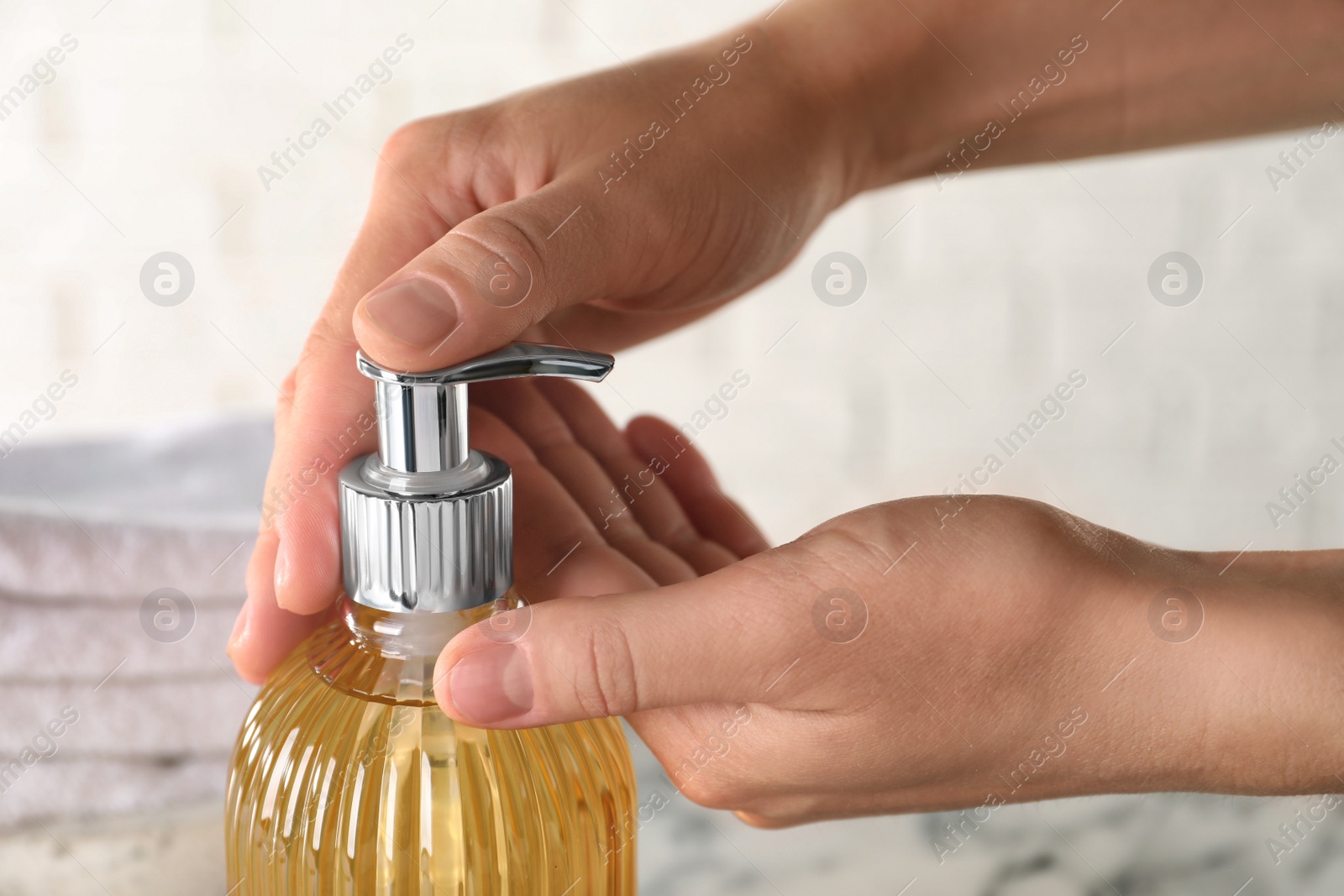 Photo of Woman using liquid soap dispenser, closeup view