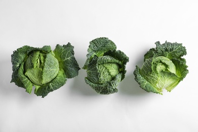 Photo of Fresh savoy cabbages on white background, top view