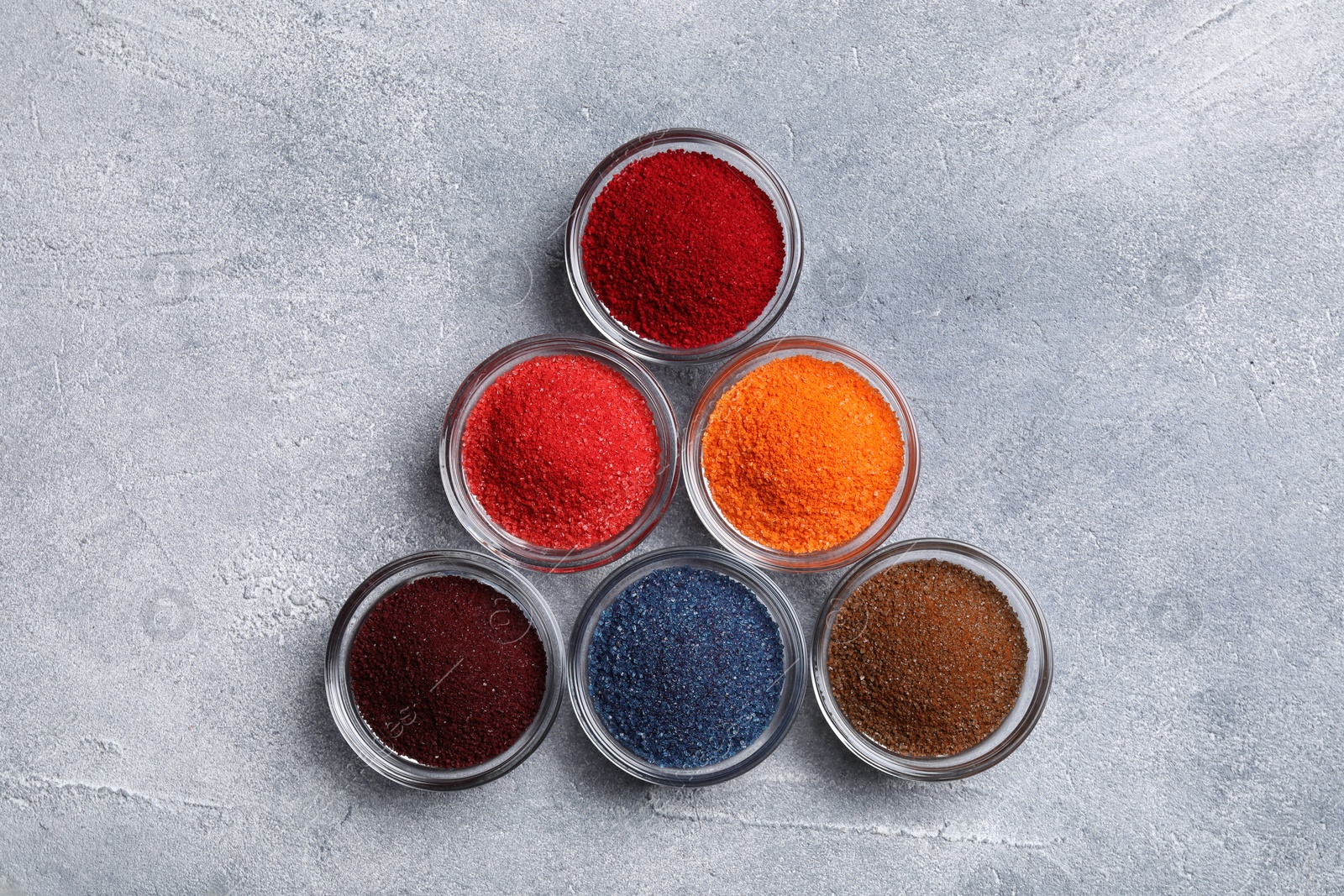 Photo of Different food coloring on light grey table, flat lay