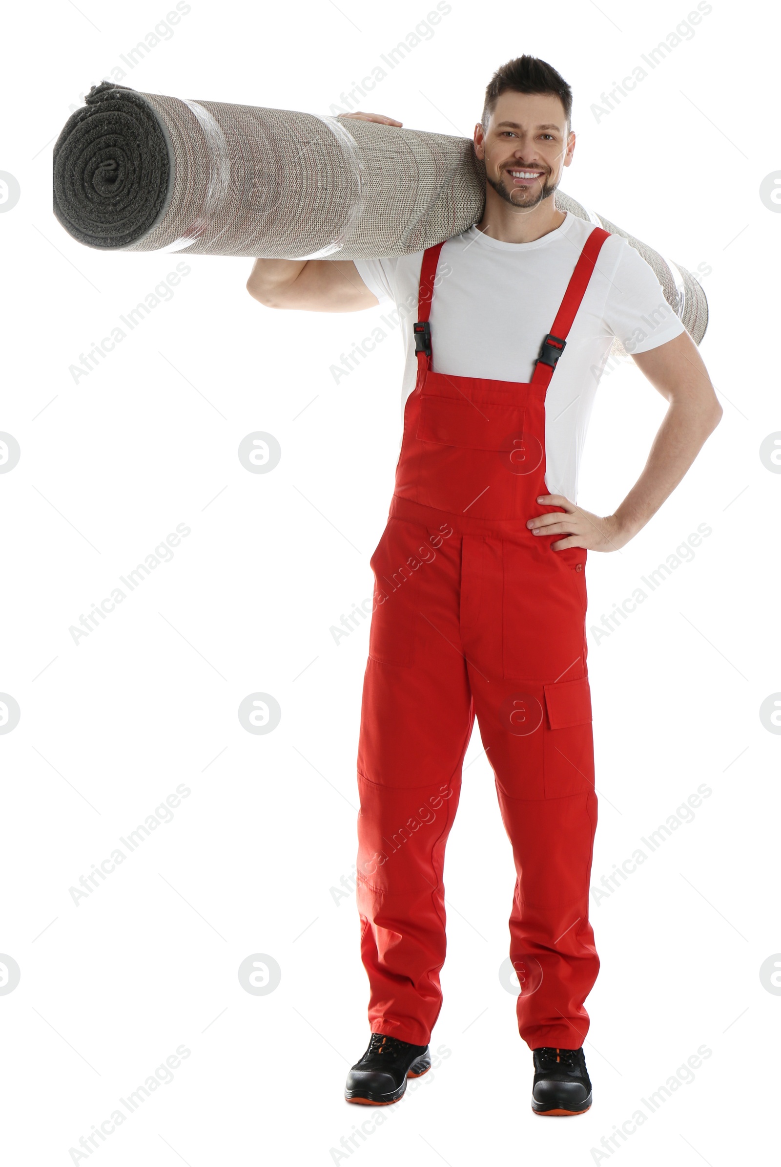 Photo of Male worker with rolled carpet on white background