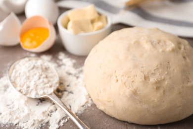 Photo of Wheat dough and products on table, closeup. Cooking pastries