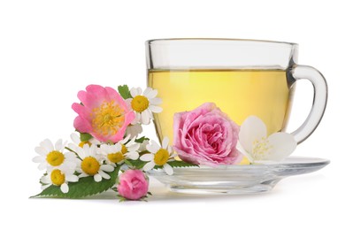 Photo of Aromatic herbal tea in glass cup and flowers isolated on white