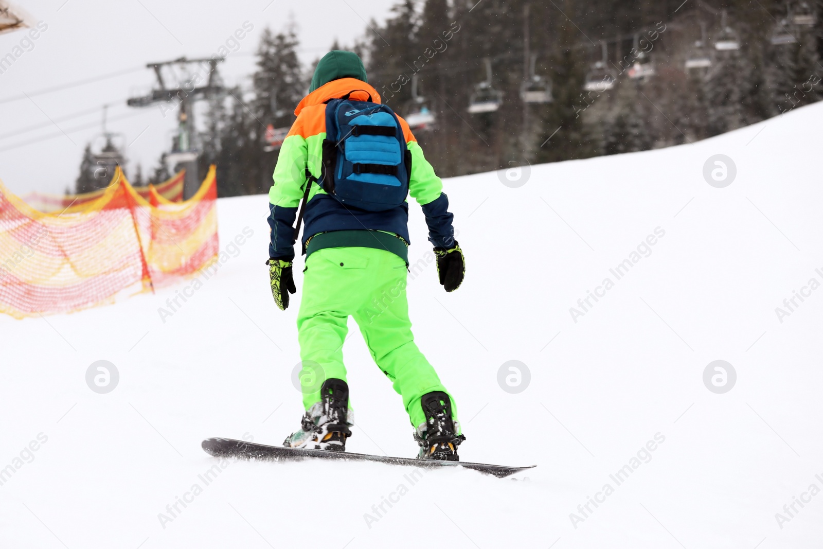 Photo of Snowboarder on slope at resort. Winter vacation