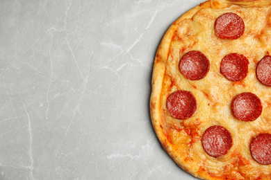 Photo of Tasty pepperoni pizza on light grey marble table, top view. Space for text