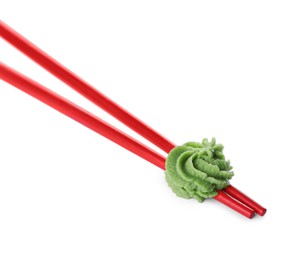 Photo of Chopsticks with swirl of wasabi paste isolated on white