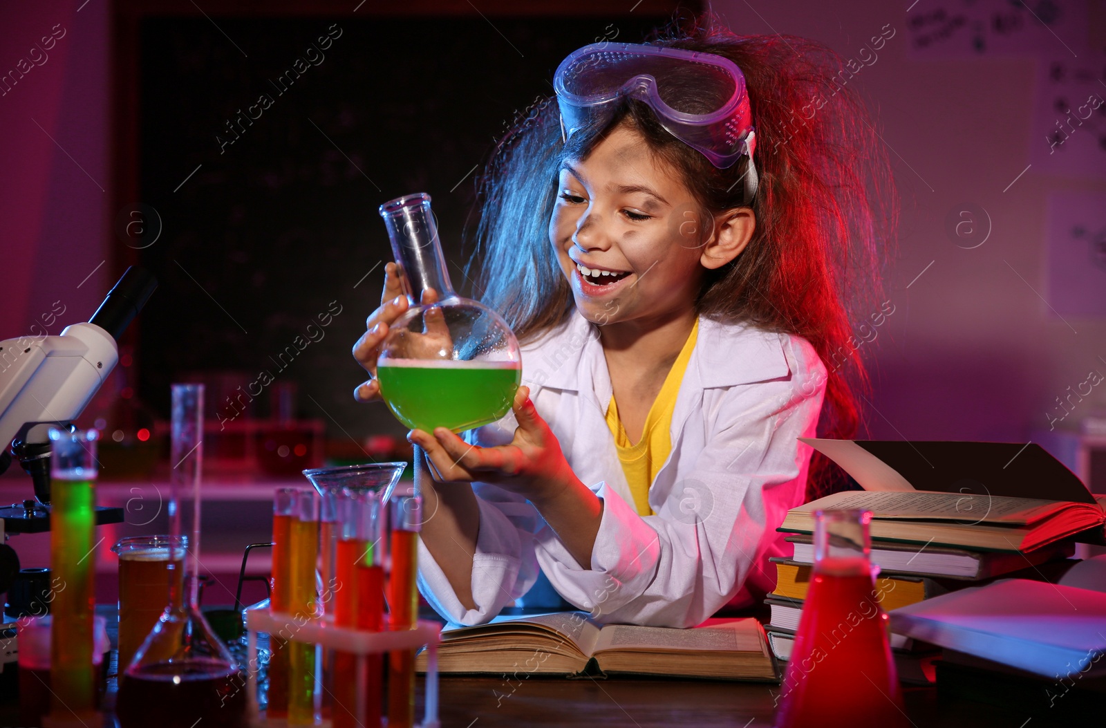 Photo of Child doing chemical research in laboratory. Dangerous experiment