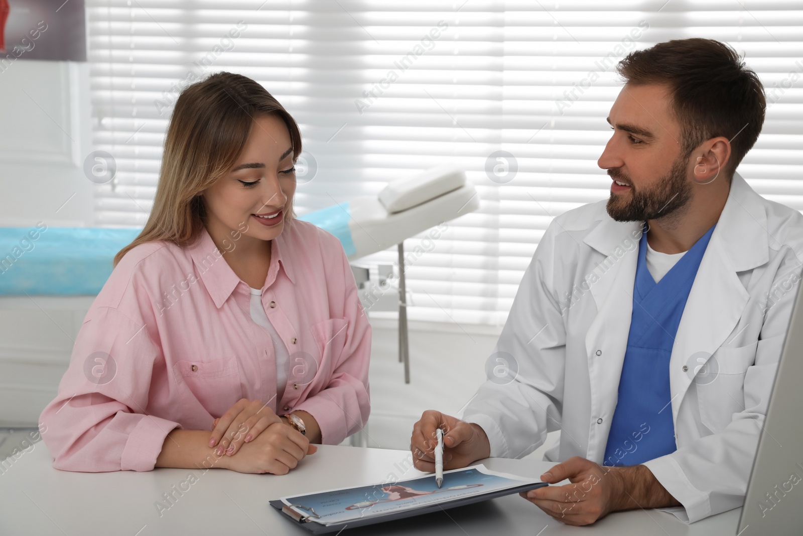 Photo of Young woman having appointment with gynecologist in clinic