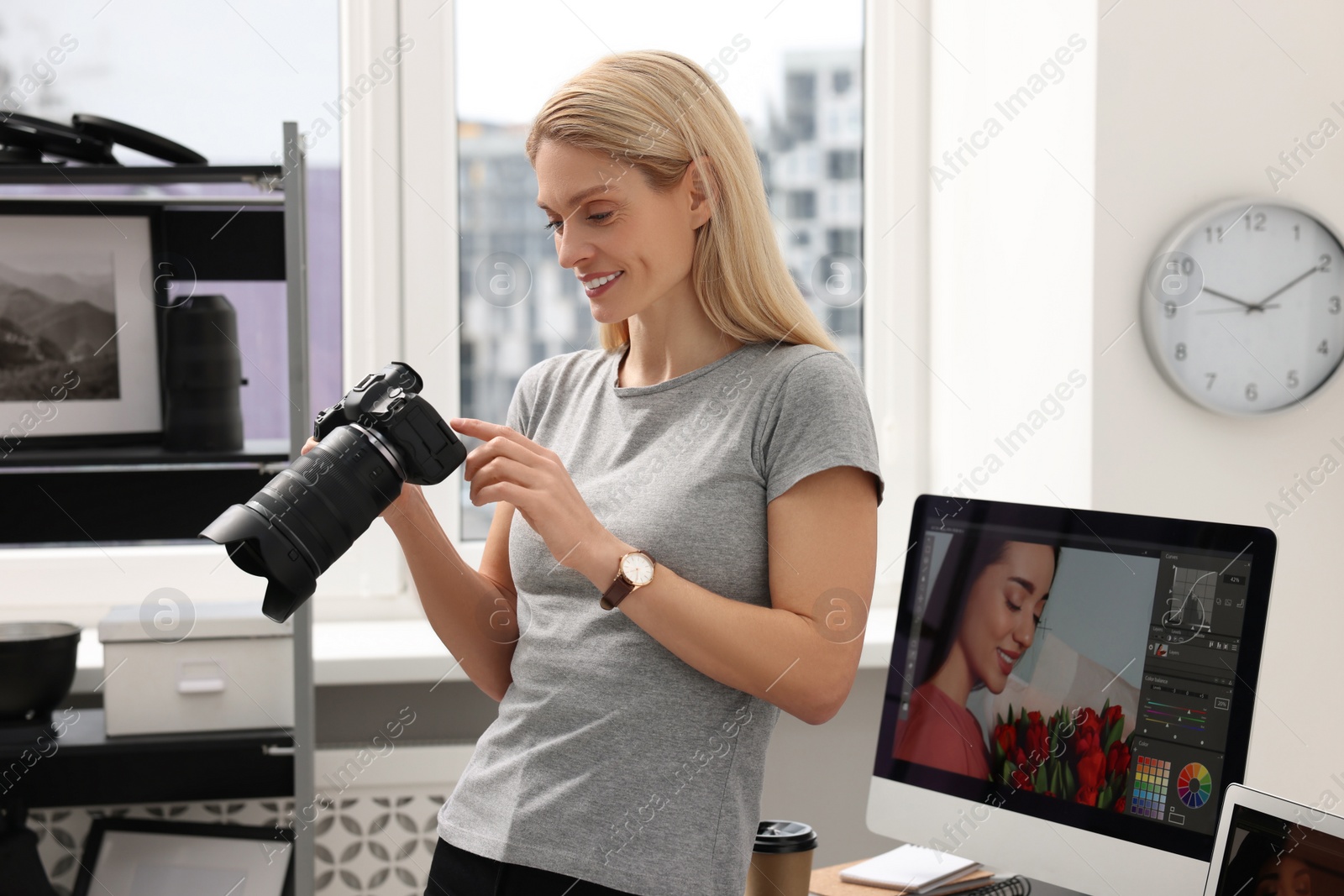 Photo of Professional photographer with modern digital camera in office