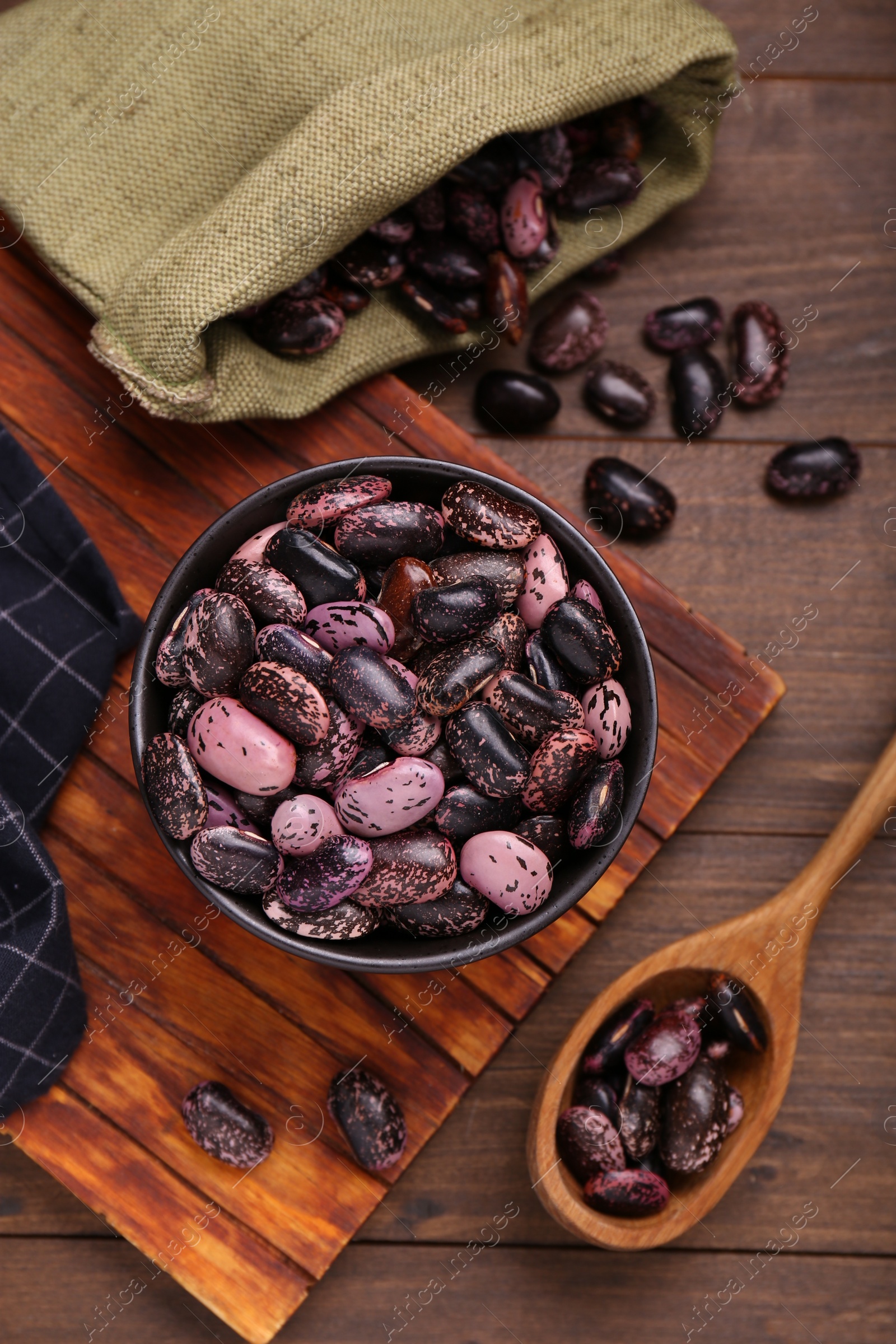 Photo of Many dry kidney beans on wooden table, flat lay