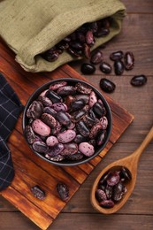 Photo of Many dry kidney beans on wooden table, flat lay