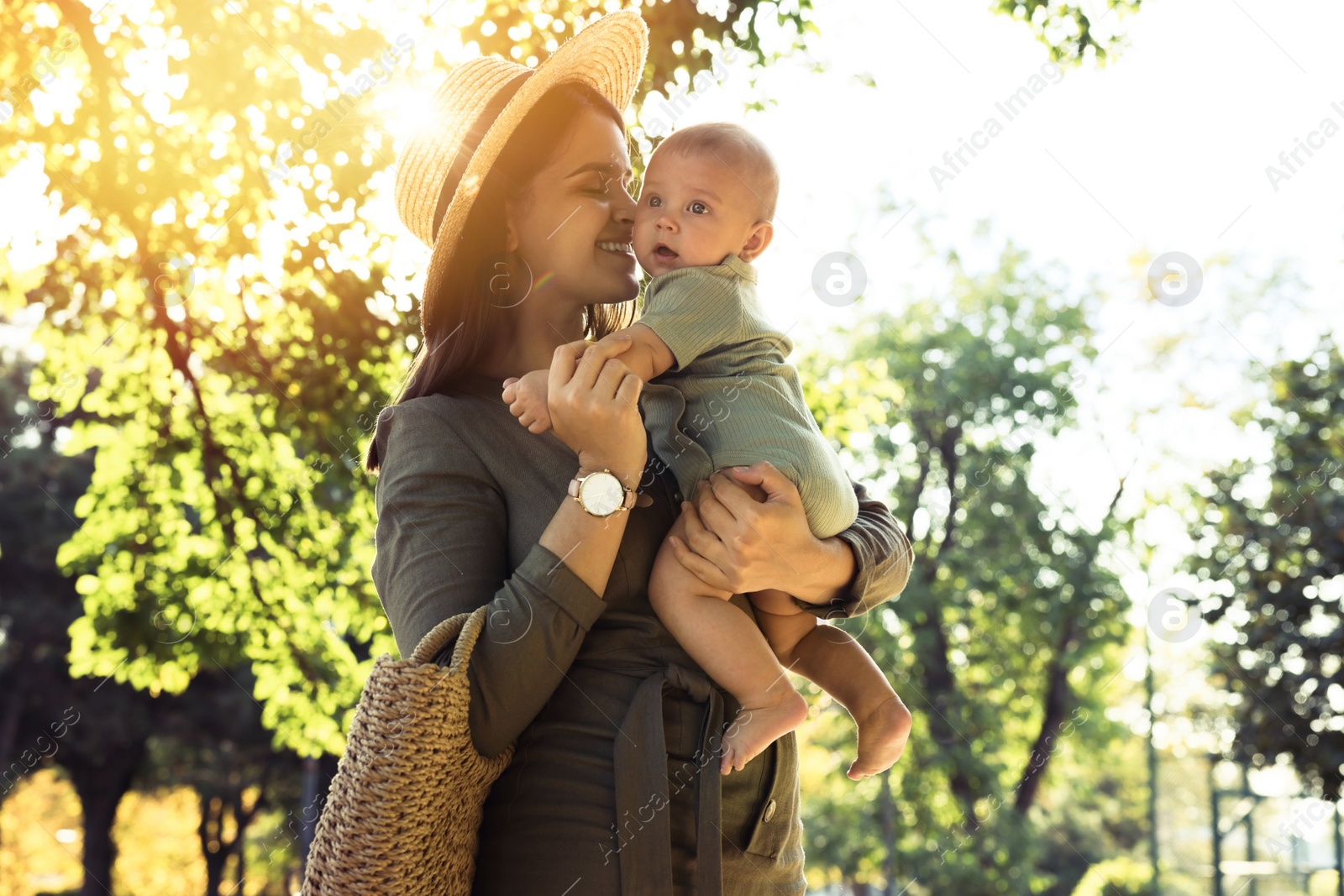 Photo of Young mother with her cute baby in park on sunny day