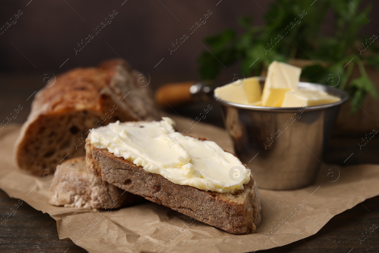 Photo of Tasty bread with butter on table, closeup