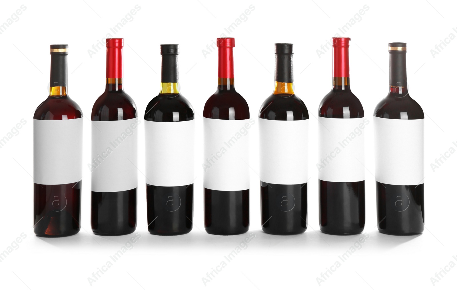 Photo of Bottles with red wine on white background