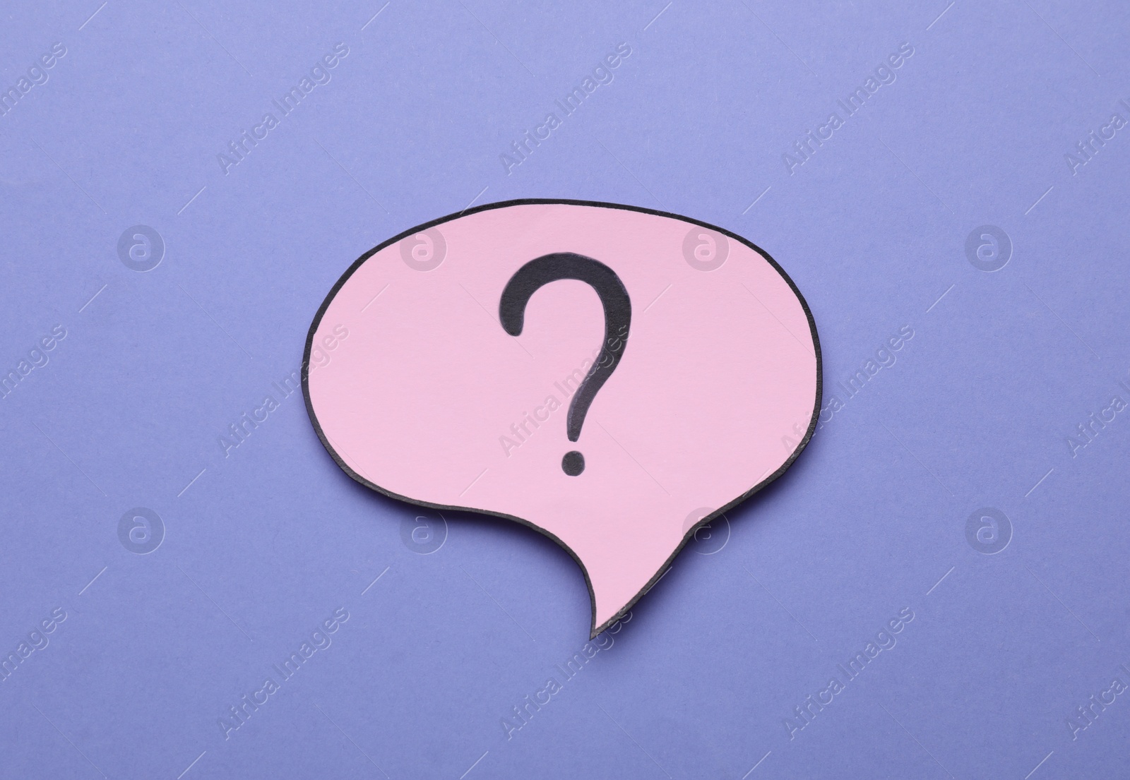 Photo of Paper speech bubble with question mark on violet background, above view