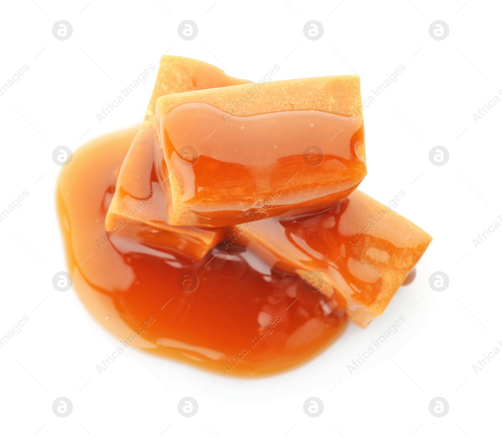 Photo of Delicious candies with caramel sauce on white background