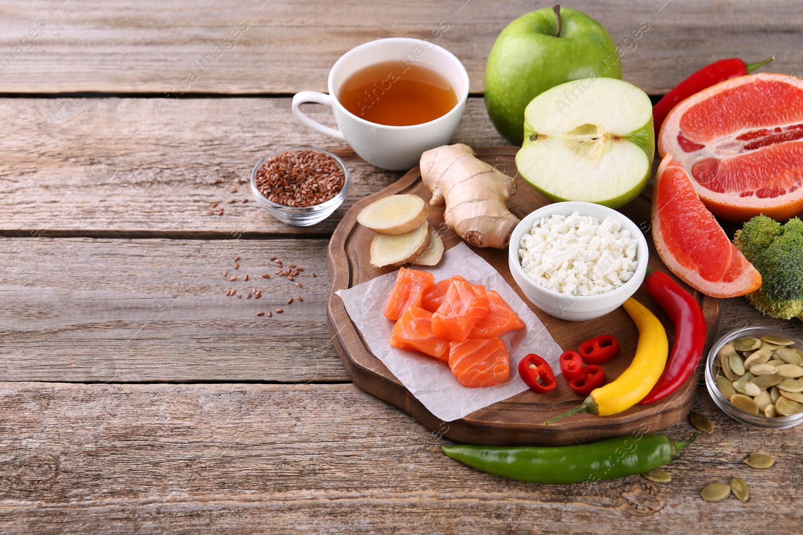 Photo of Metabolism. Different food products on old wooden table, space for text