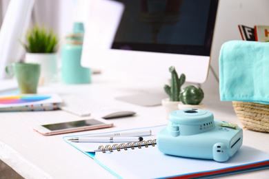 Photo of Digital camera on table in studio. Modern designer's workplace