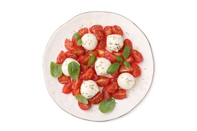 Plate of tasty salad Caprese with tomatoes, mozzarella balls and basil isolated on white, top view