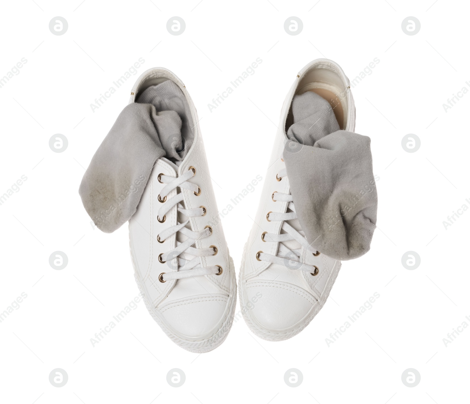 Photo of Dirty socks and sneakers on white background, top view