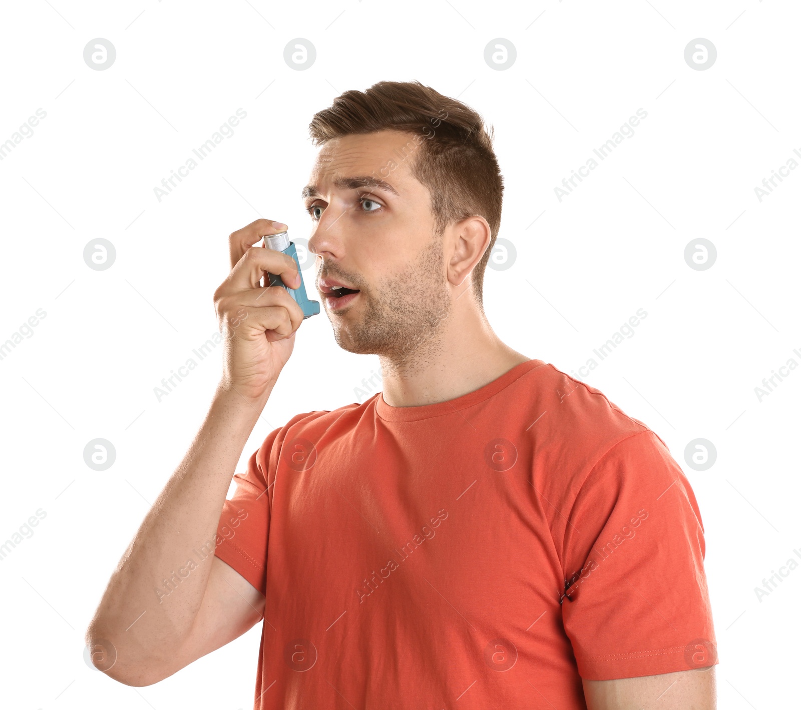 Photo of Young man with asthma using inhaler on white background